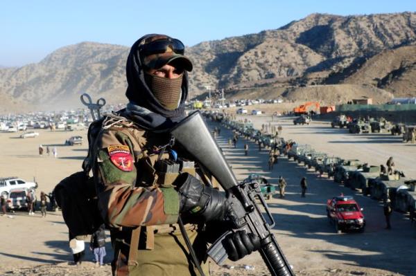 Taliban fighters stand guard